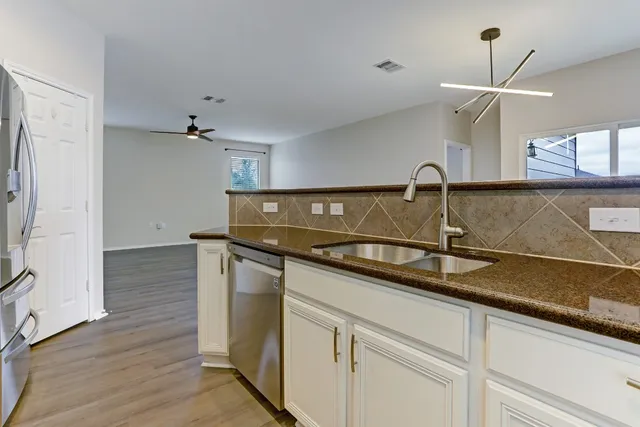 a kitchen with a sink and a refrigerator