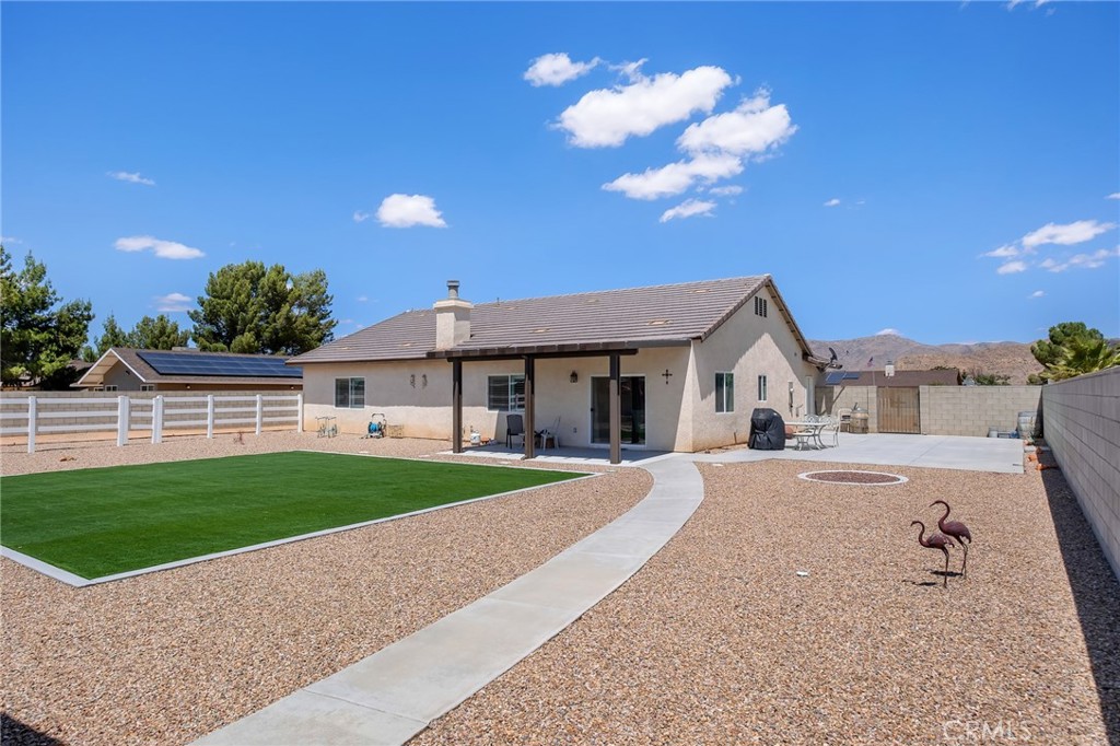 13178 Setancket Road Apple Valley, CA 92308 - Photo 23 of 24 a front view of a house with a yard and garage