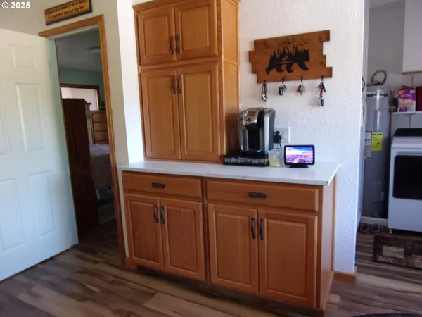 a kitchen with a sink cabinets and wooden floor