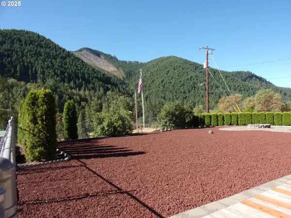 a view of a road with a house in the background