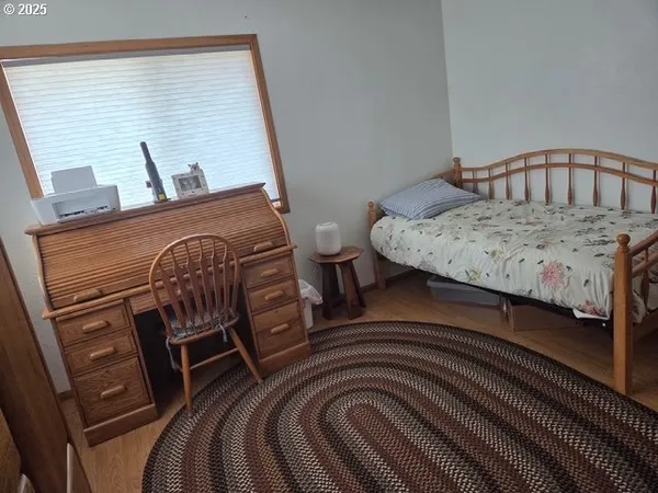 a room with wooden floor and furniture