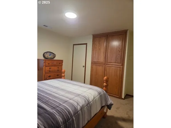 a bedroom with a bed and a cabinets