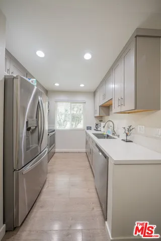 a kitchen with granite countertop a sink and stainless steel appliances