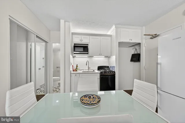 a kitchen with stainless steel appliances granite countertop a refrigerator stove and sink