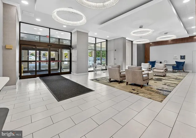 a living room with furniture and a book shelf