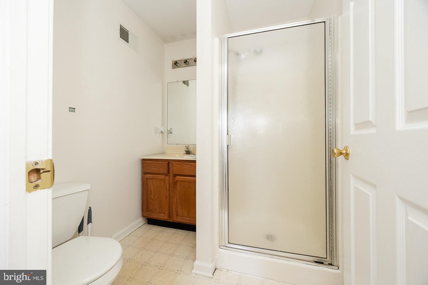 350 Andrew Road Coatesville, PA 19320 - Photo 14 of 20 a bathroom with a granite countertop sink mirror vanity and toilet
