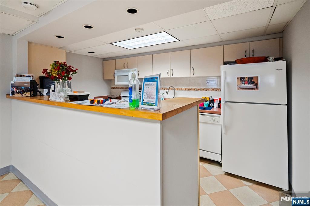 280 Prospect Avenue, Unit 8G Hackensack, NJ 07601 - Photo 23 of 23 a kitchen with refrigerator and cabinets