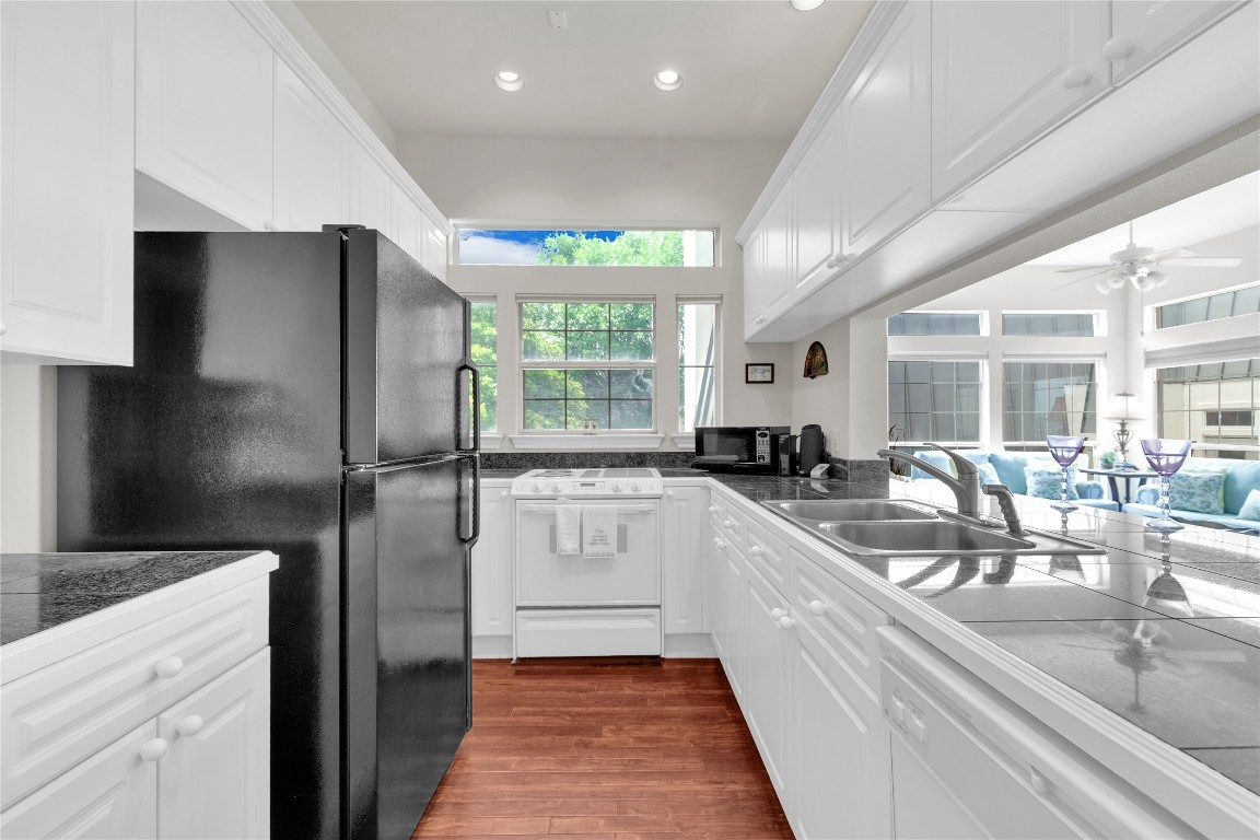 2918 Ranch Road 620 North, Unit L173 Austin, TX 78734 - Photo 11 of 35 Kitchen featuring black appliances, a sink, white cabinets, and recessed lighting