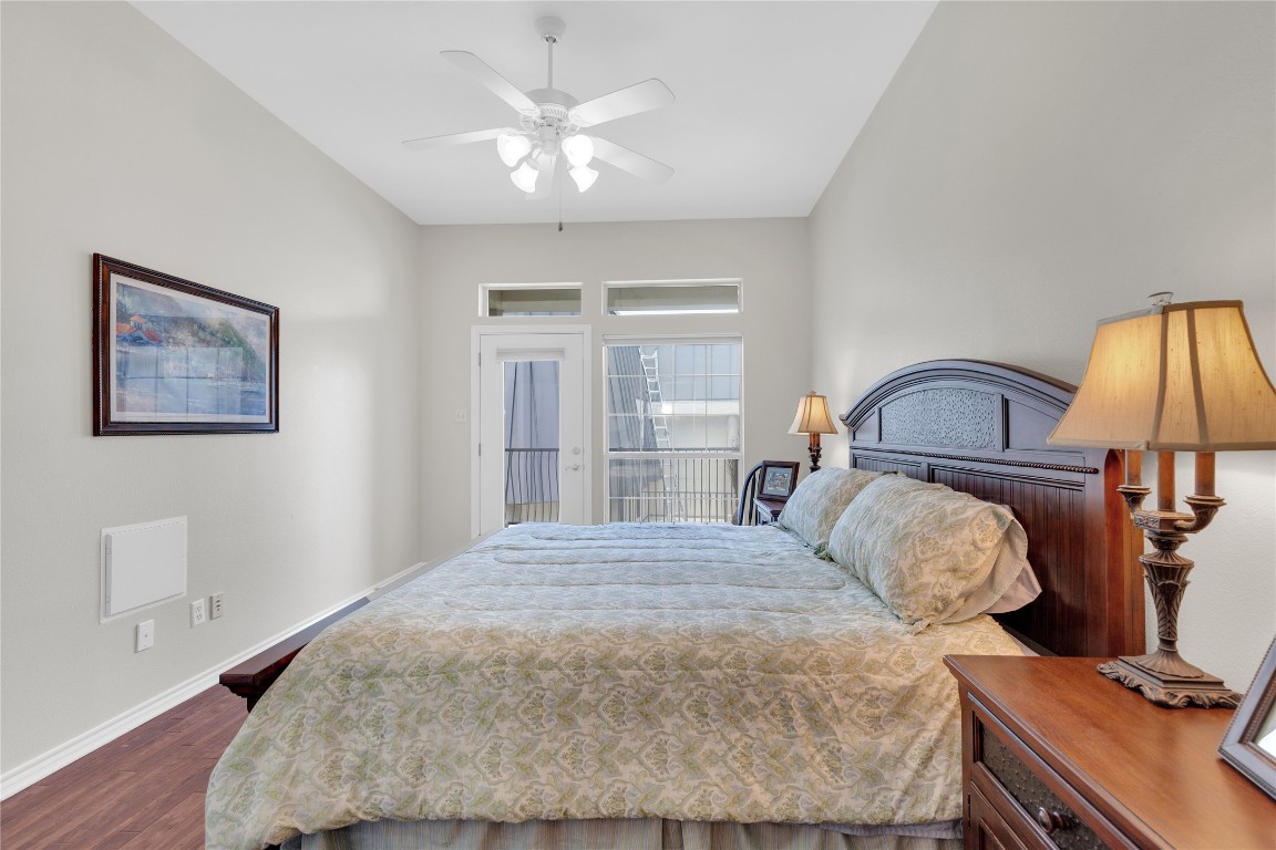 2918 Ranch Road 620 North, Unit L173 Austin, TX 78734 - Photo 13 of 35 Bedroom featuring dark wood-style flooring, baseboards, access to outside, and ceiling fan
