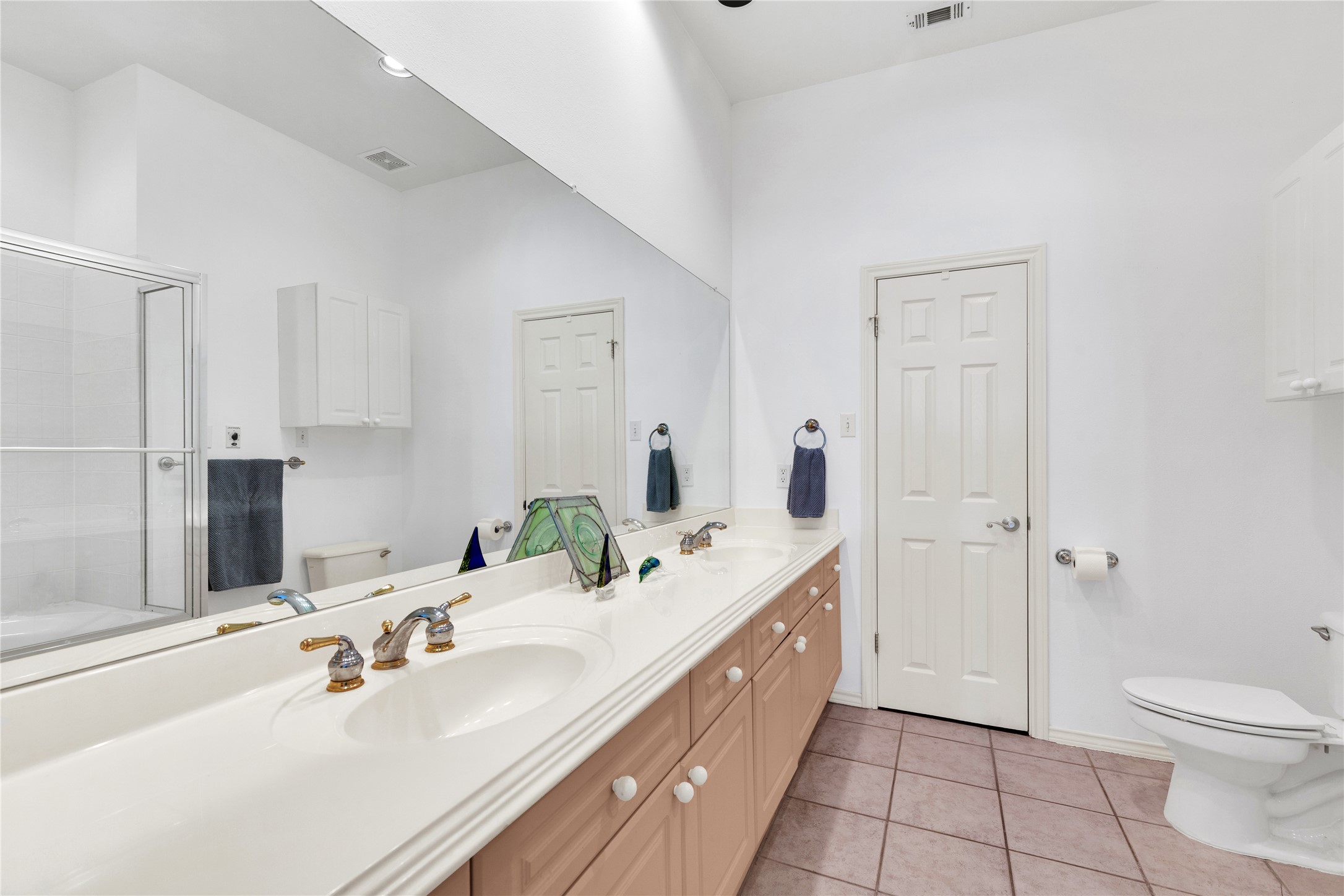 2918 Ranch Road 620 North, Unit L173 Austin, TX 78734 - Photo 15 of 35 a bathroom with a double vanity sink toilet and shower