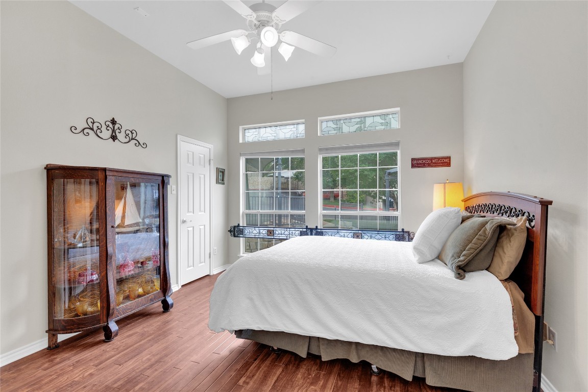 2918 Ranch Road 620 North, Unit L173 Austin, TX 78734 - Photo 18 of 35 Bedroom featuring wood finished floors, baseboards, a towering ceiling, and ceiling fan