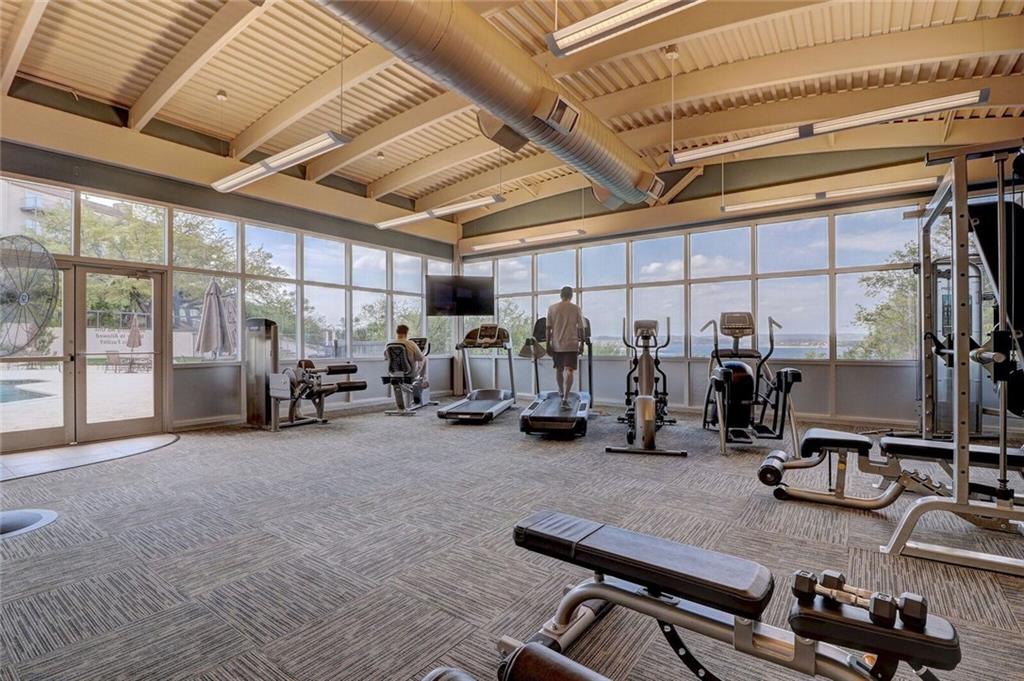 2918 Ranch Road 620 North, Unit L173 Austin, TX 78734 - Photo 29 of 35 Gym with carpet flooring, plenty of natural light, french doors, beam ceiling, and a high ceiling