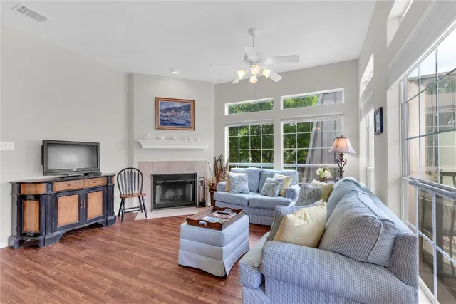 a living room with furniture and a wooden floor