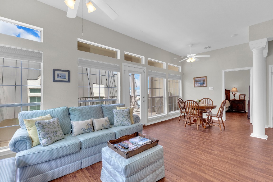 2918 Ranch Road 620 North, Unit L173 Austin, TX 78734 - Photo 4 of 35 Living area featuring a ceiling fan, healthy amount of natural light, decorative columns, and a towering ceiling