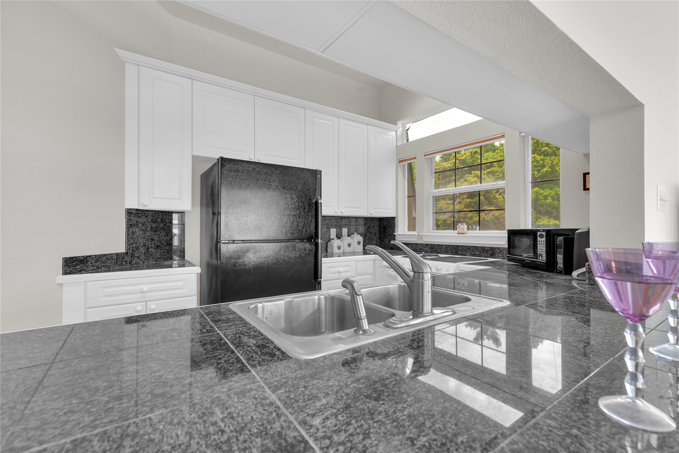 2918 Ranch Road 620 North, Unit L173 Austin, TX 78734 - Photo 10 of 35 a kitchen with granite countertop a coffee maker a sink a stove and a refrigerator