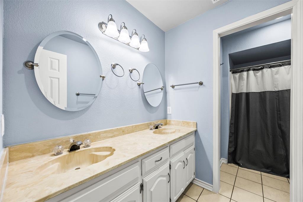 909 Valley View Avenue Red Oak, TX 75154 - Photo 26 of 37 a bathroom with a double vanity sink and a mirror