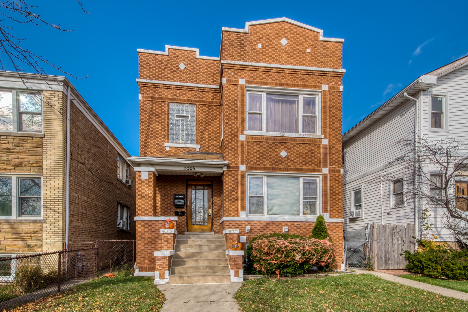 5306 West Roscoe Street, Unit 2 Chicago, IL 60641 - Photo 1 of 12 a front view of a house with garden