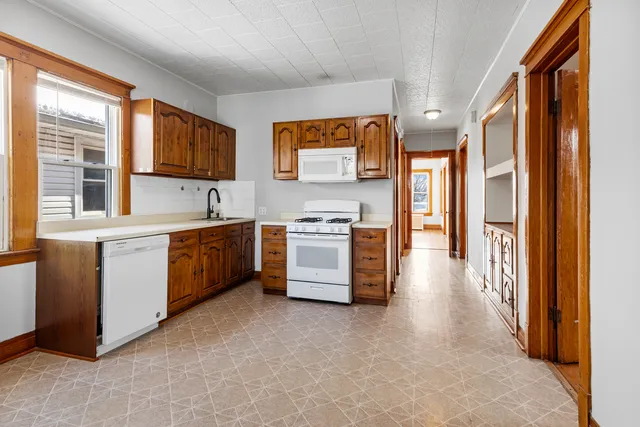 a kitchen with stainless steel appliances granite countertop a stove a sink and a refrigerator