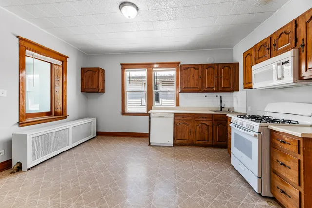 a kitchen with stainless steel appliances a stove a sink and a refrigerator