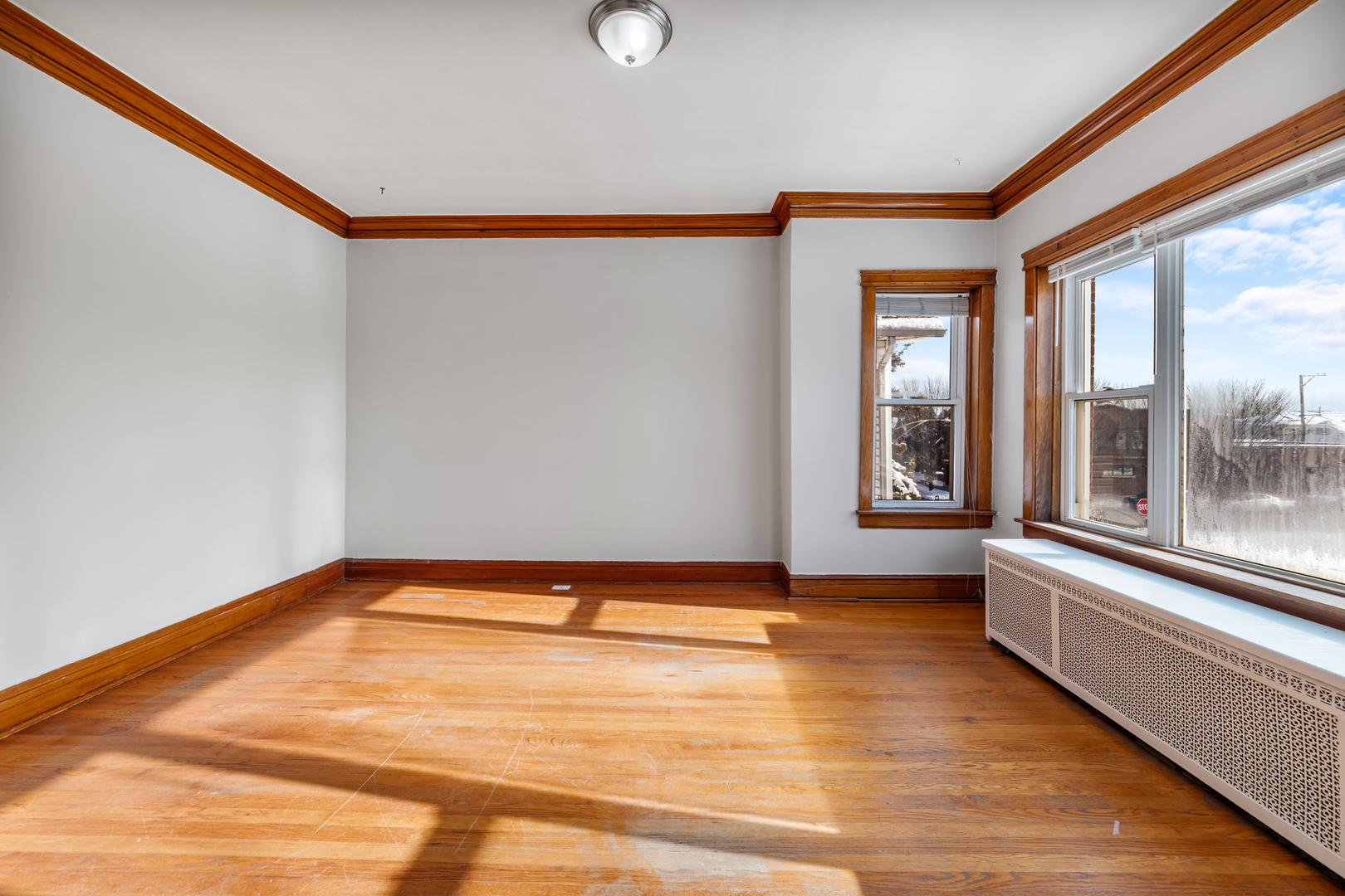 5306 West Roscoe Street, Unit 2 Chicago, IL 60641 - Photo 5 of 12 a view of a room with wooden floor and large window