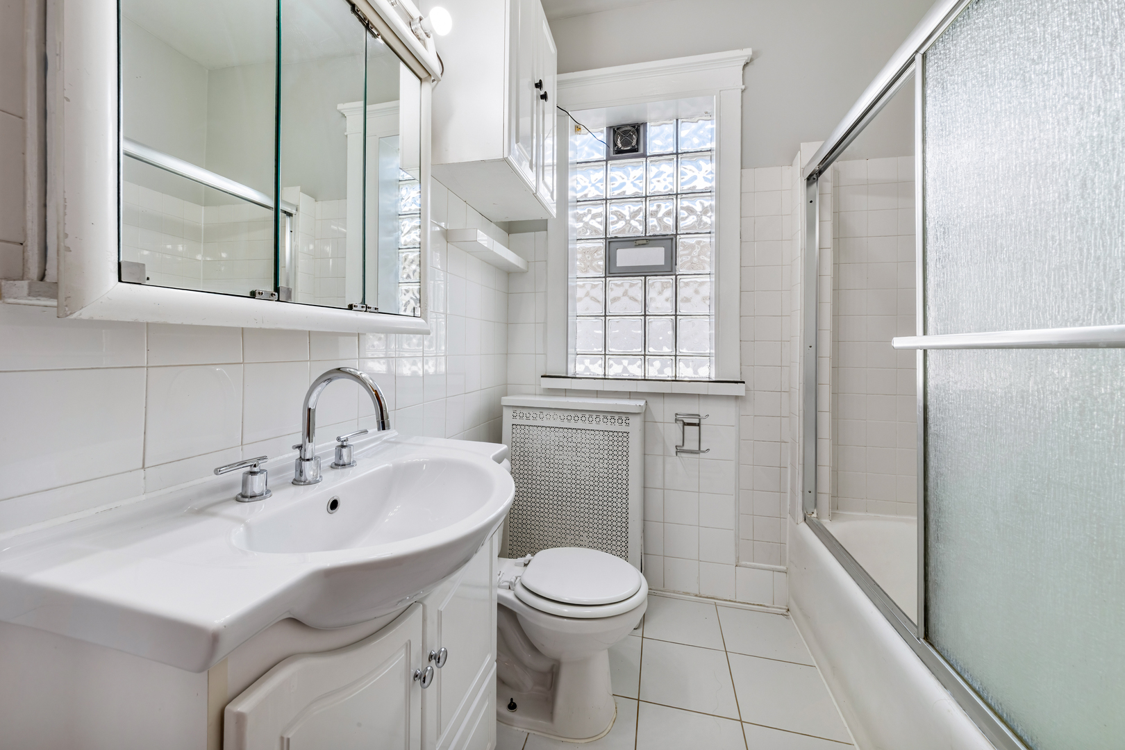 5306 West Roscoe Street, Unit 2 Chicago, IL 60641 - Photo 9 of 12 a bathroom with a sink toilet and shower