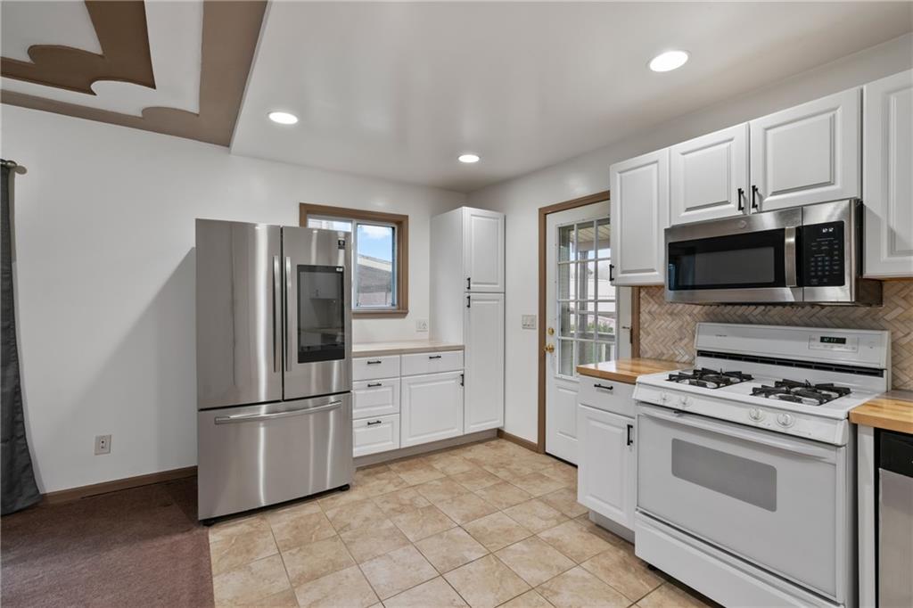 927 Greenhill Road Pittsburgh, PA 15209 - Photo 12 of 41 a kitchen with stainless steel appliances white cabinets and a refrigerator