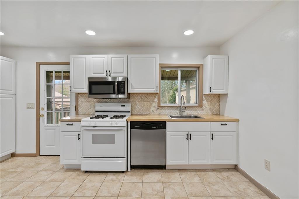 927 Greenhill Road Pittsburgh, PA 15209 - Photo 5 of 41 a kitchen with a sink stove and microwave