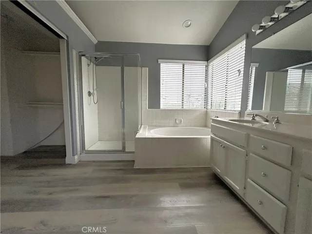 a bathroom with a tub sink shower and mirror