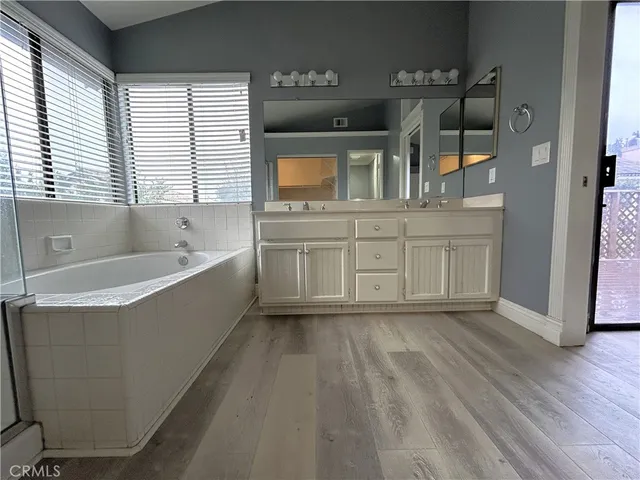 a spacious bathroom with a bathtub and a sink