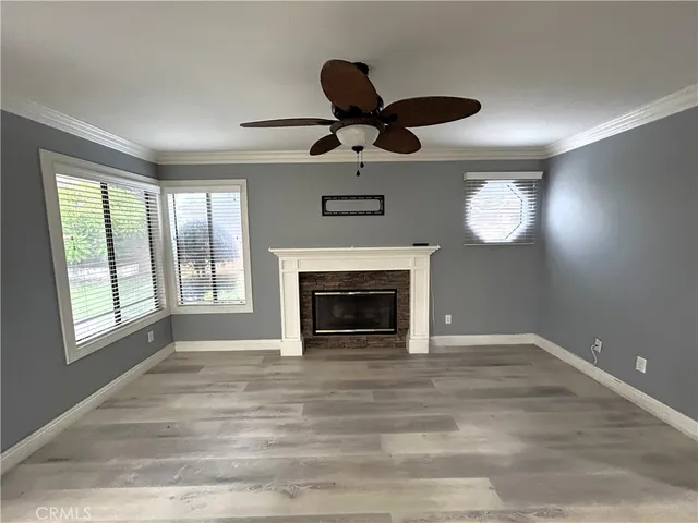 a view of an empty room with a fireplace and a window