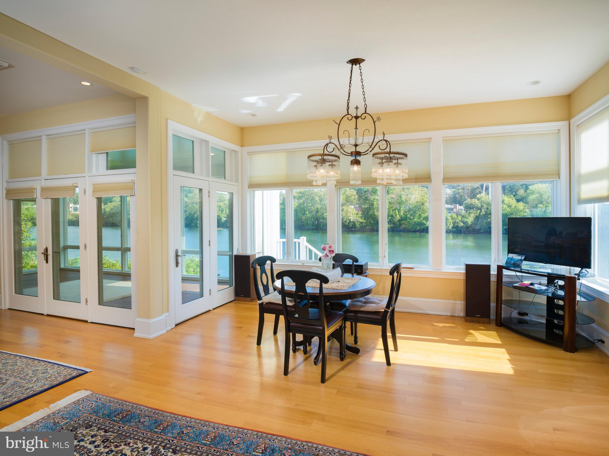 236 River Road Gladwyne, PA 19035 - Photo 19 of 50 a dining room with furniture a chandelier and wooden floor