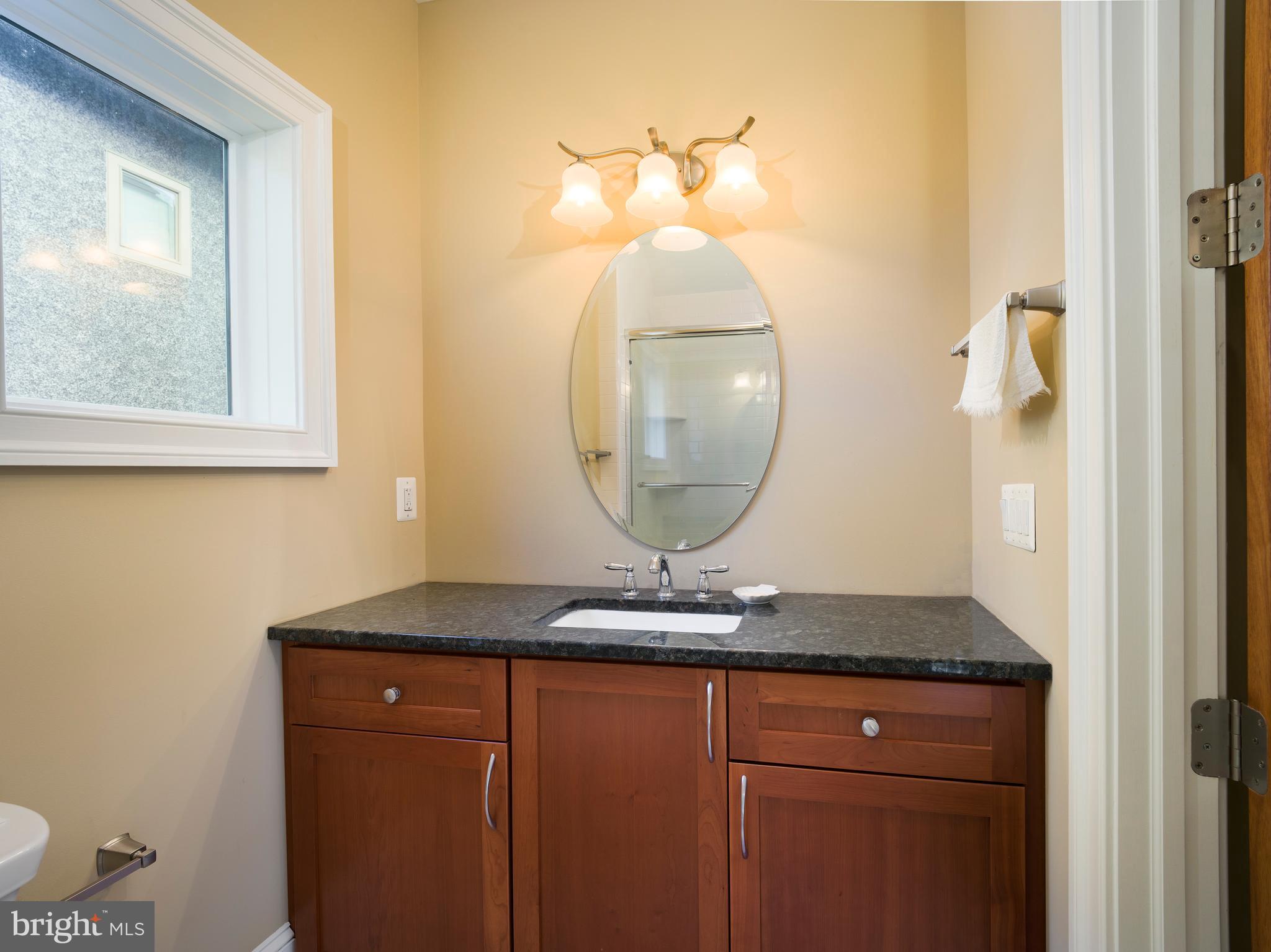 236 River Road Gladwyne, PA 19035 - Photo 25 of 50 a bathroom with a granite countertop sink and a mirror