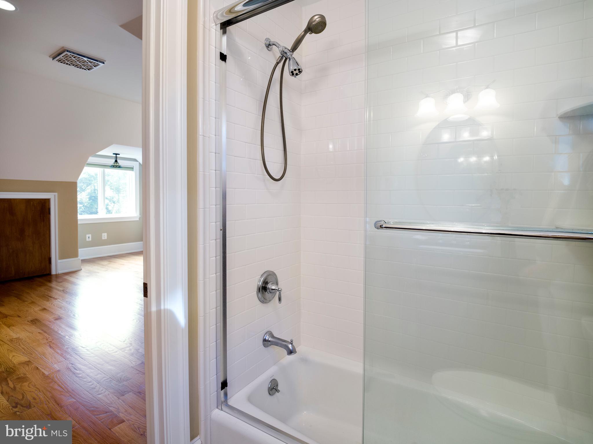 236 River Road Gladwyne, PA 19035 - Photo 26 of 50 a bathroom with a glass shower door and a window