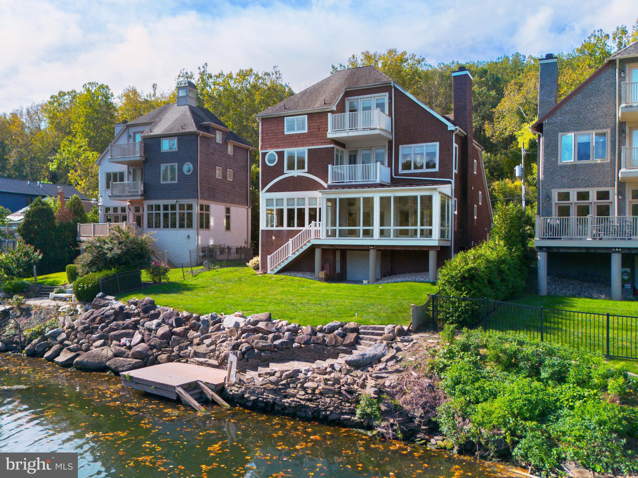 236 River Road Gladwyne, PA 19035 - Photo 3 of 50 a front view of a house with a yard and large trees