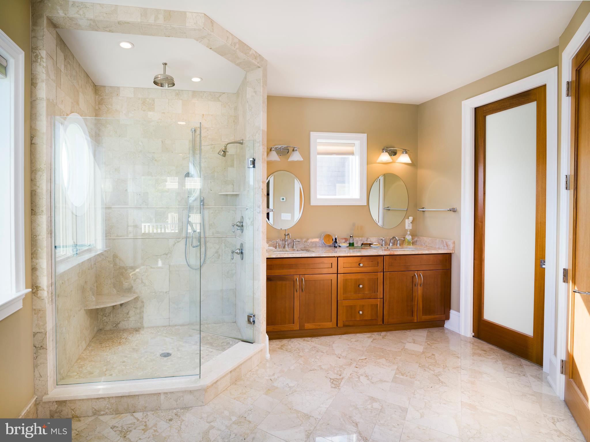 236 River Road Gladwyne, PA 19035 - Photo 32 of 50 a bathroom with a granite countertop sink a mirror and shower