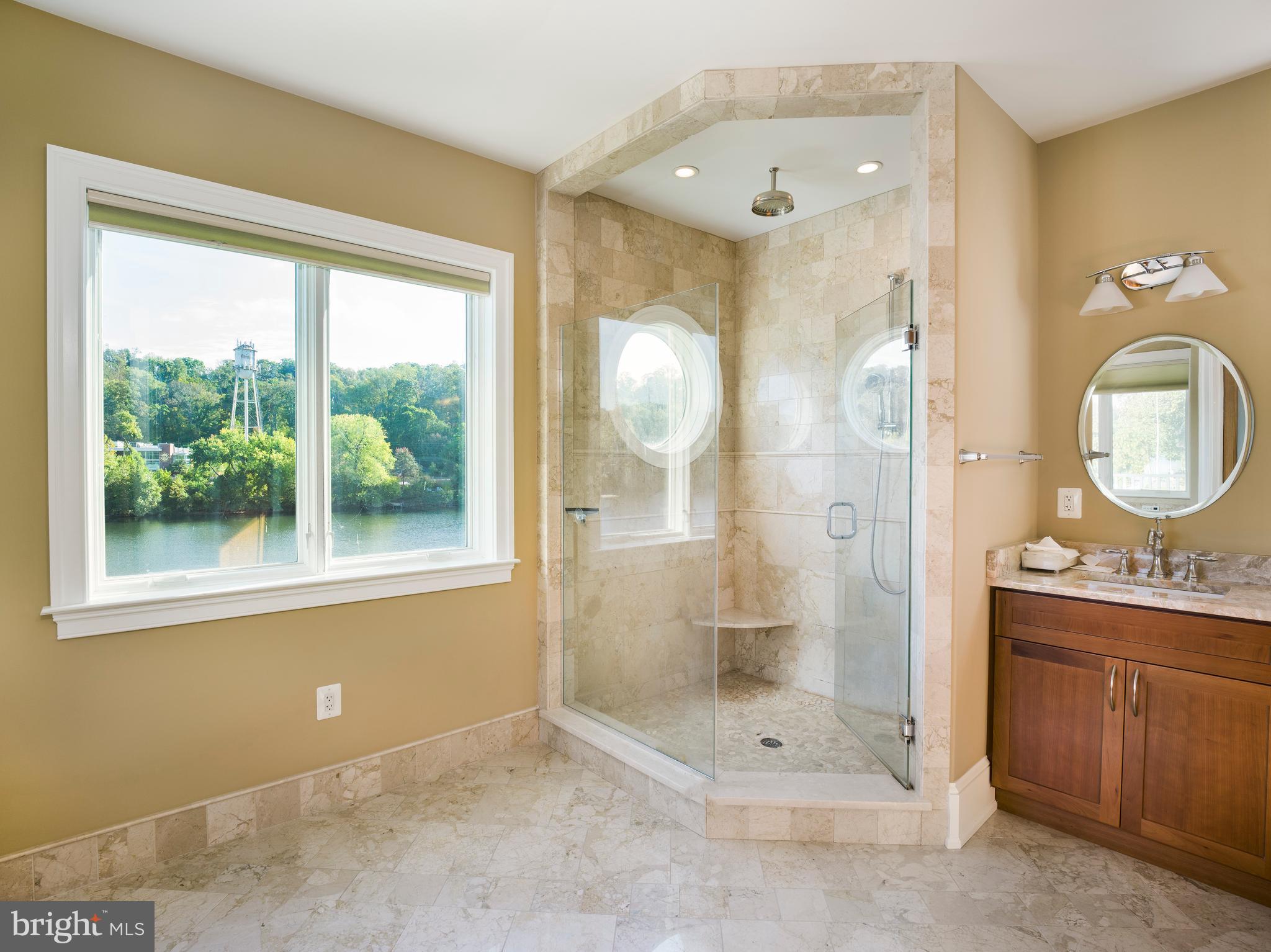236 River Road Gladwyne, PA 19035 - Photo 33 of 50 a bathroom with a shower a sink and a mirror