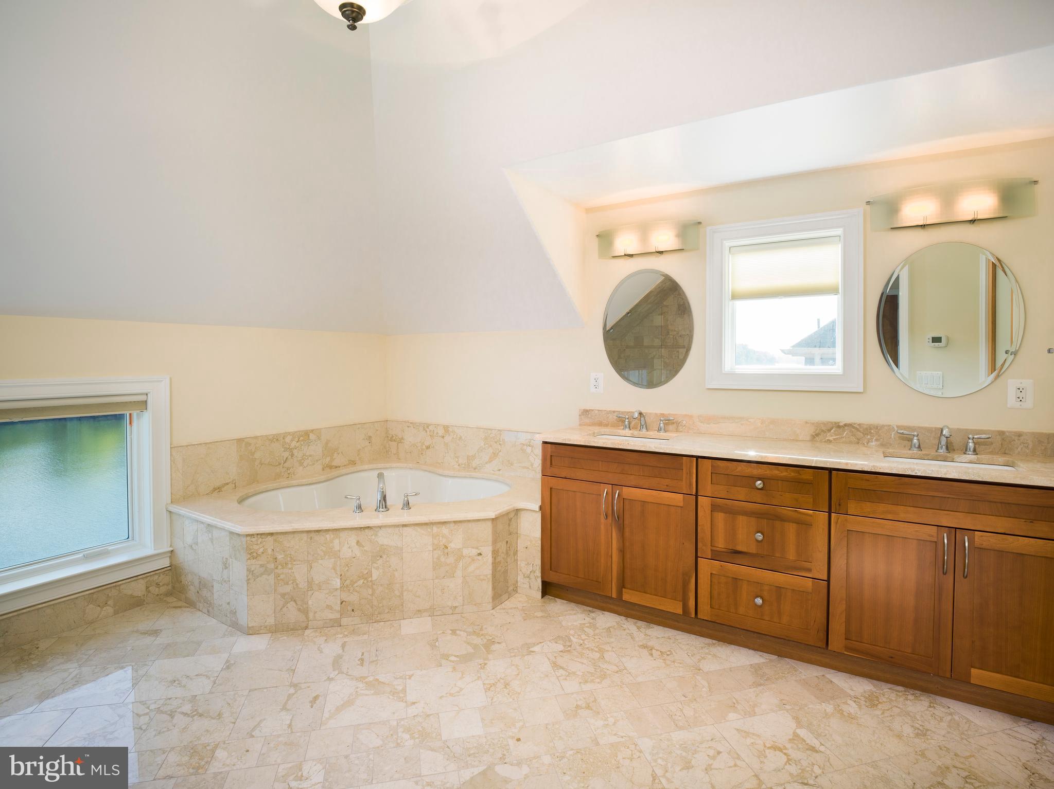 236 River Road Gladwyne, PA 19035 - Photo 42 of 50 a spacious bathroom with a tub sink and mirror