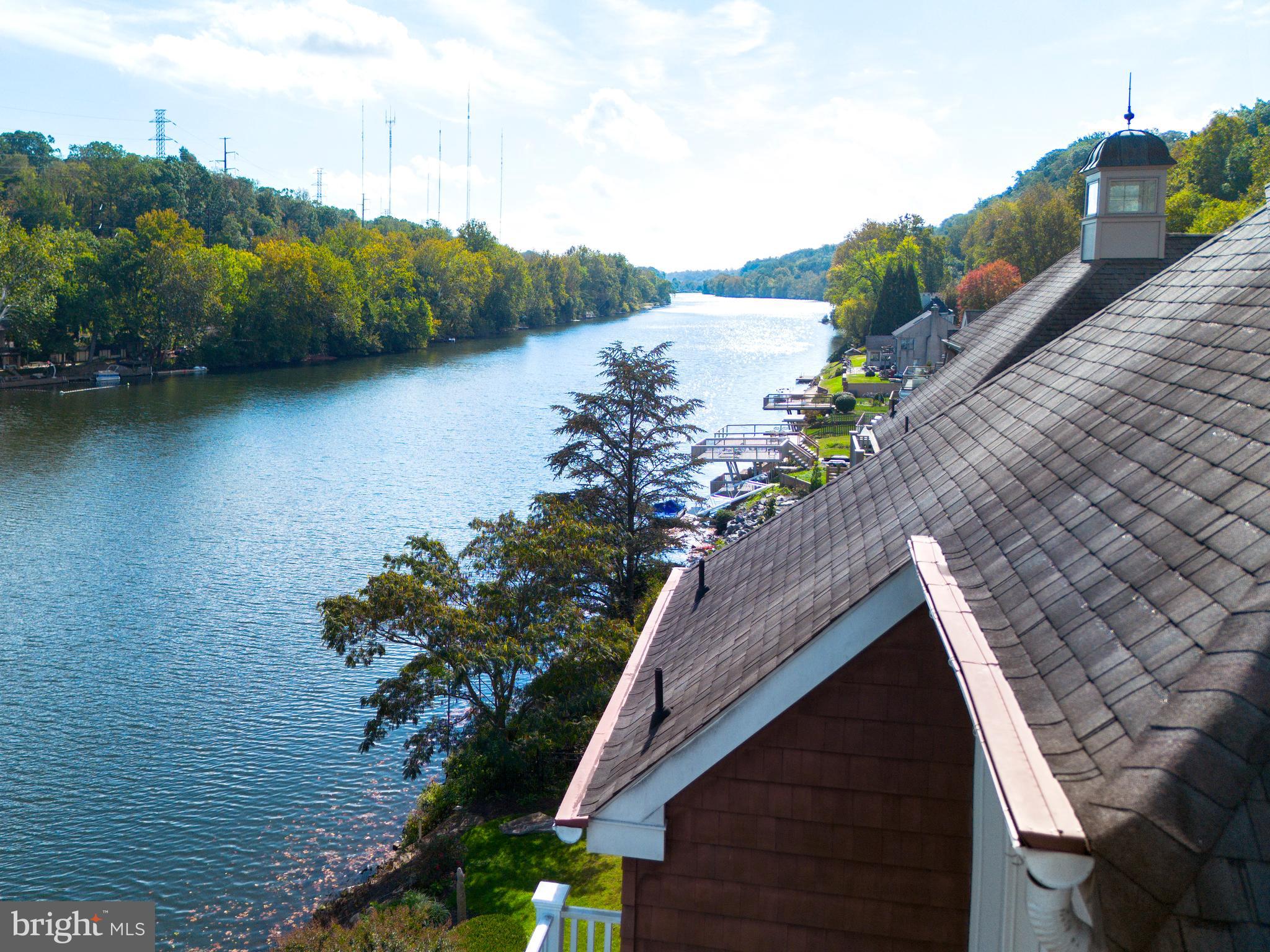 236 River Road Gladwyne, PA 19035 - Photo 49 of 50 a view of a lake with a floor to ceiling window and potted plants