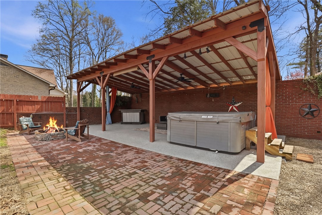 4304 Old Buncombe Road Greenville, SC 29617 - Photo 38 of 49 This spacious backyard oasis features a covered patio and a fire pit, perfect for entertaining.