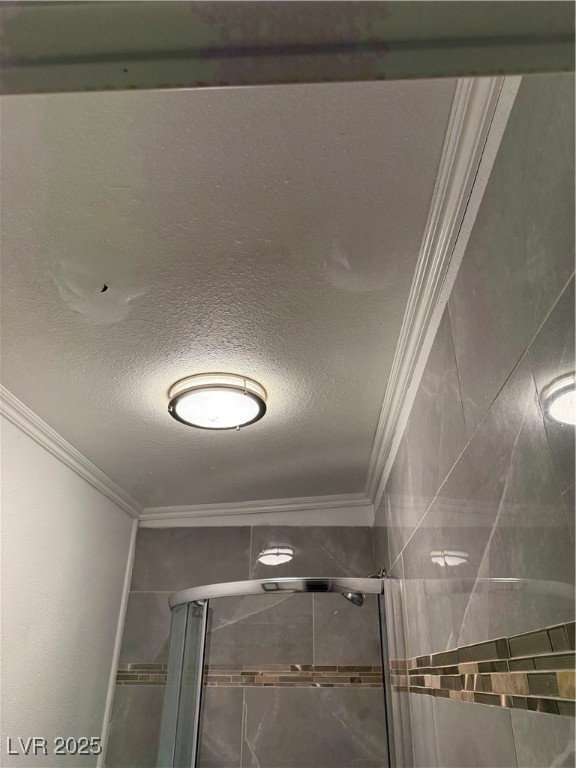 5171 Reeder Circle, Unit C Las Vegas, NV 89119 - Photo 16 of 17 Bathroom view of a textured ceiling, crown molding, and a shower stall