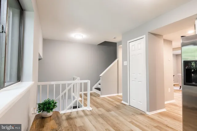 a view of entryway and hall with wooden floor