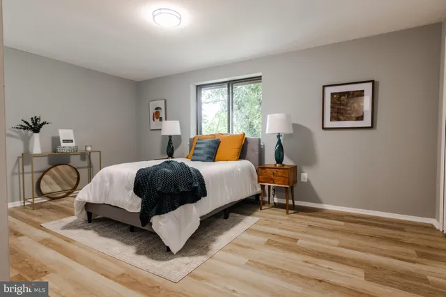 a bedroom with a bed lamp and window