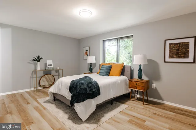 a bed room with a bed and a chair