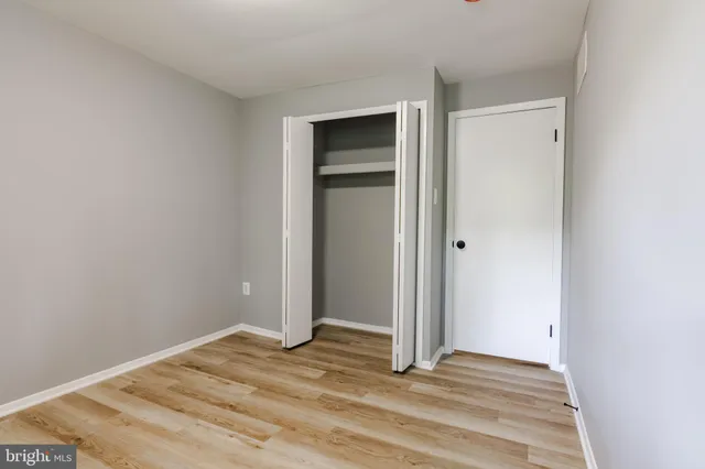 a view of a room with a wooden door