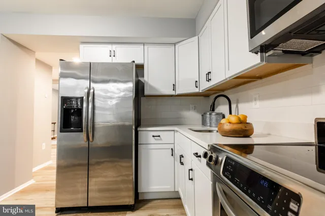 a kitchen with a refrigerator and a stove
