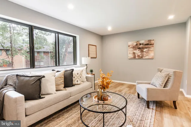 a living room with furniture and a large window