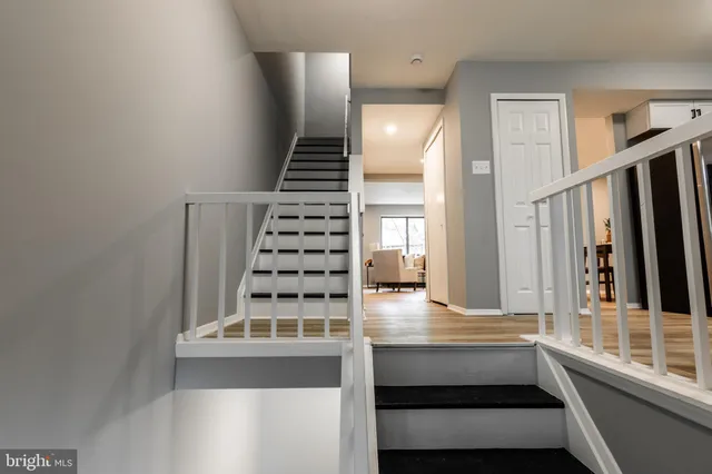 a view of entryway and hall with wooden floor