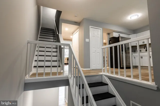 a view of entryway and hall with wooden floor