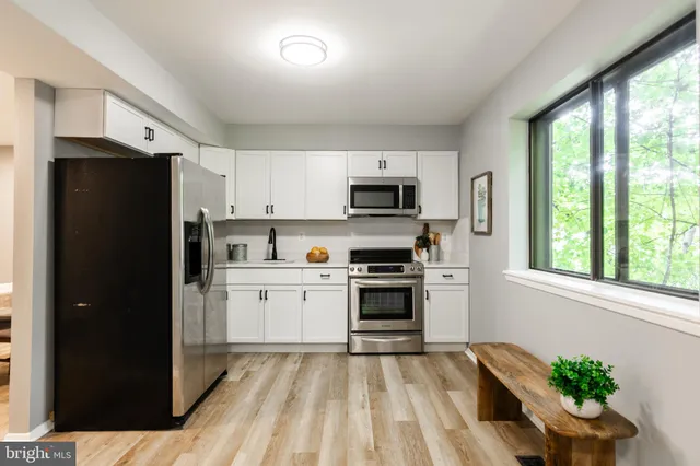 a kitchen with a refrigerator a stove top oven a sink and dishwasher