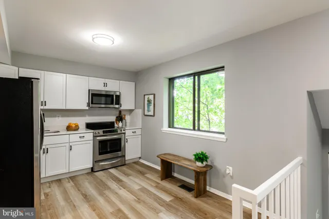 a kitchen with stove cabinets and refrigerator